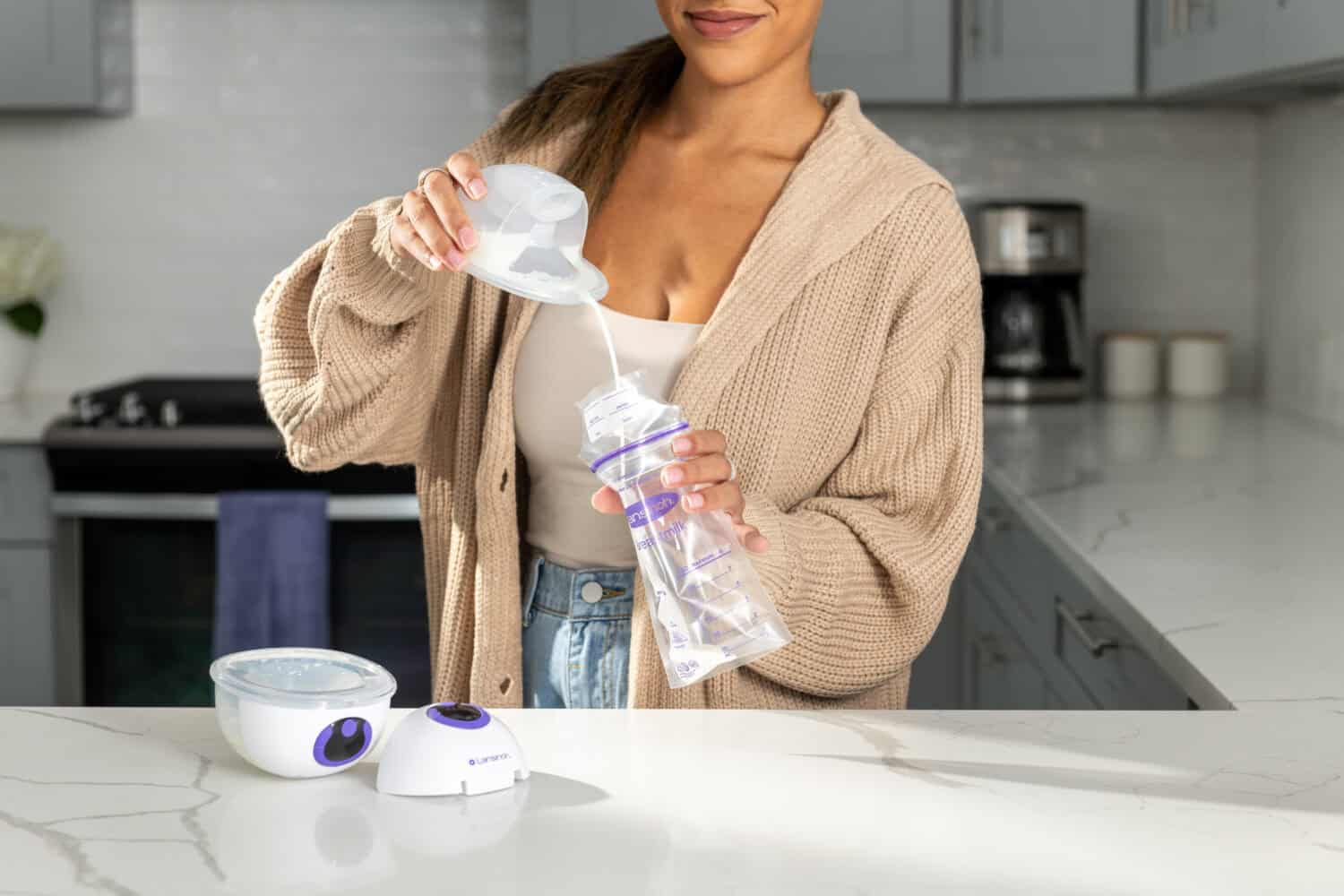 Women Pouring milk into milk bag from Lansinoh Discreet Duo